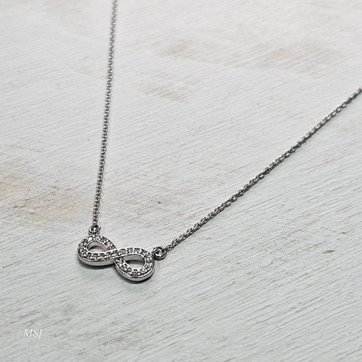 10k White Gold .11ctw Infinity Diamond Pendant