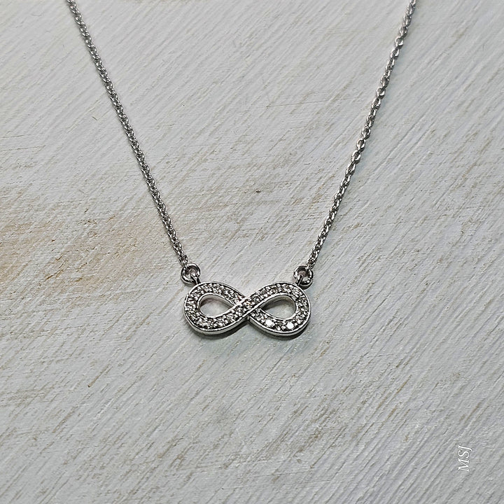 10k White Gold .11ctw Infinity Diamond Pendant
