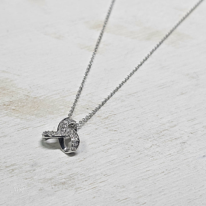 10k White Gold .08ctw Love Knot Diamond Pendant