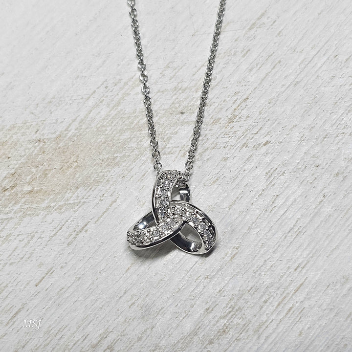 10k White Gold .08ctw Love Knot Diamond Pendant