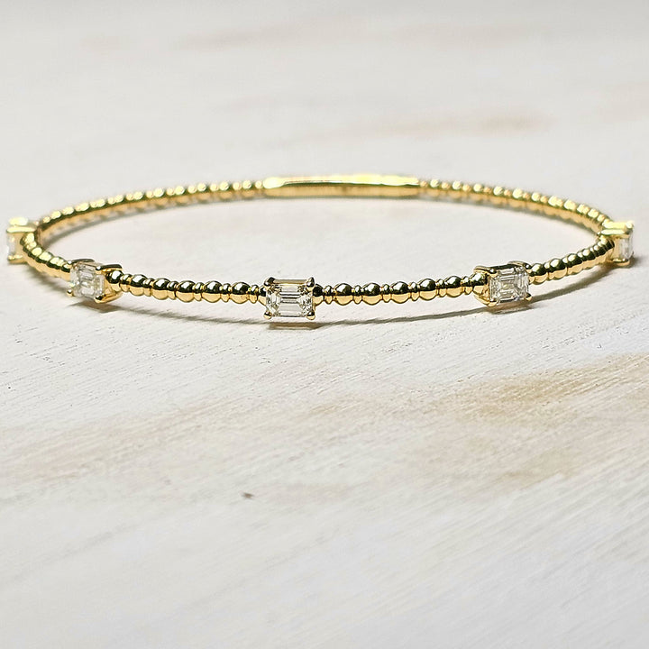 14k Yellow Gold Flexi Bangle with 1.5ctw Emerald Cut Diamonds