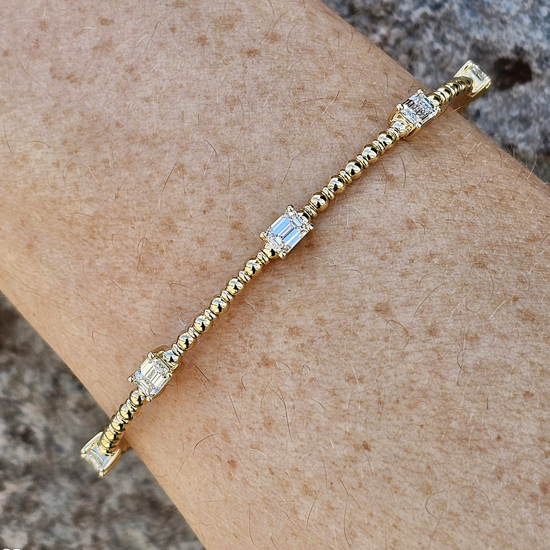 14k Yellow Gold Flexi Bangle with 1.5ctw Emerald Cut Diamonds