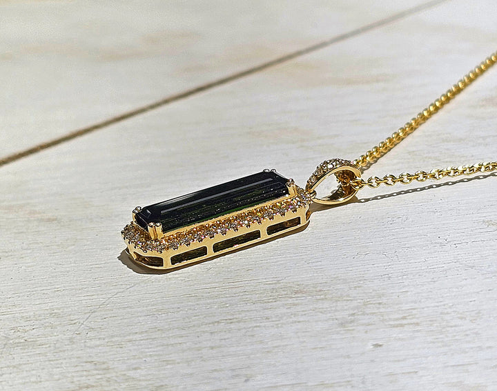 14k Yellow Gold chrome tourmaline pendant features a center stone of 5.09 carats with diamonds surrounding the center stone with a TCW of 5.45.