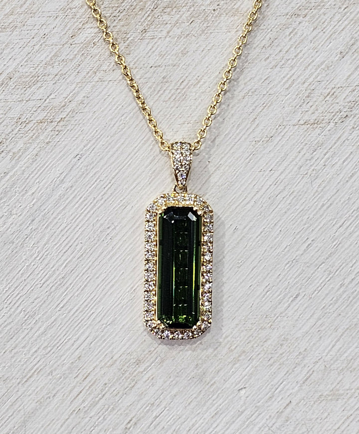 14k Yellow Gold chrome tourmaline pendant features a center stone of 5.09 carats with diamonds surrounding the center stone with a TCW of 5.45.